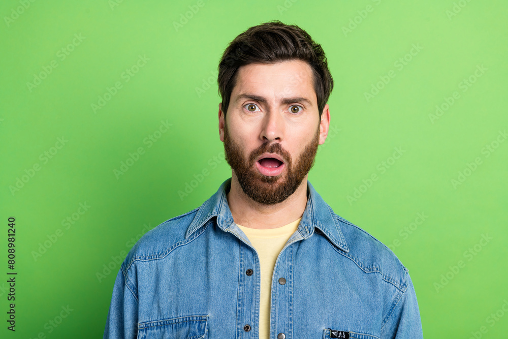 Obraz premium Photo of cheerful impressed guy dressed jeans shirt open mouth empty space isolated green color background