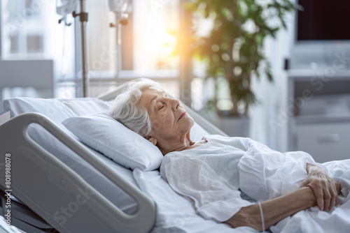 Senior woman lying in bed in hospital photo