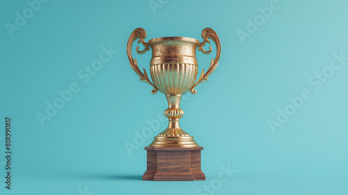 A gold trophy is sitting on a wooden base