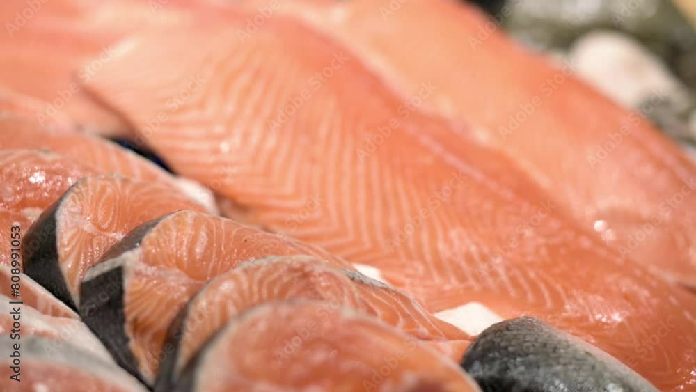 A close-up view of fresh salmon fillets displayed at a supermarket, highlighting the delicate texture and natural orange hue of the fish, perfect for health-conscious consumers. A close-up view of fresh salmon fillets displayed at a supermarket, highlighting the delicate texture and natural orange hue of the fish, perfect for health-conscious consumers.