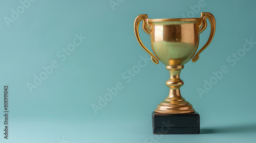A gold cup with a gold rim sits on a black base