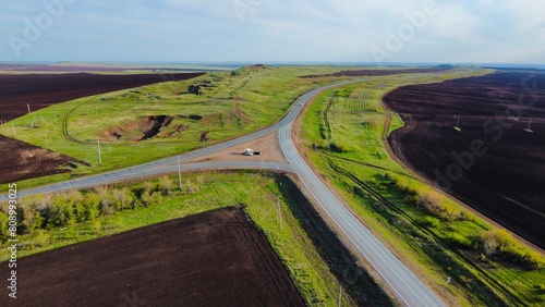 a road in spring passing by plowed fields