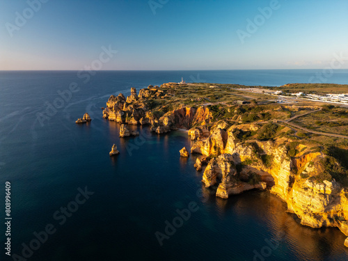 Aerial drone view of stunning cliffs Praia do Camilo in Lagos at sunrise, Algarve, Lagos, Portugal