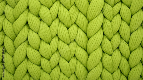 Green knitted background. Close-up of knitted texture.