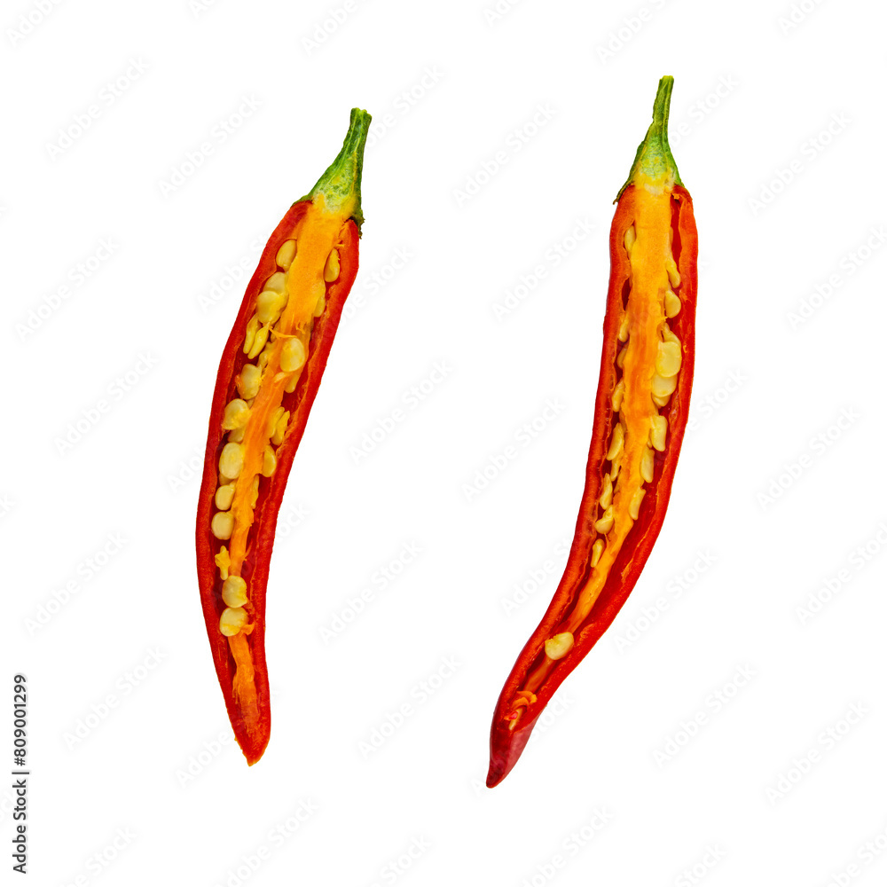 Two chili peppers are sliced open, revealing their seeds and insides Two chili peppers are sliced open, revealing their seeds and insides