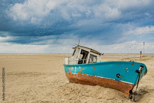 old disused boat wreck on the beach of the North Sea coast in Germany