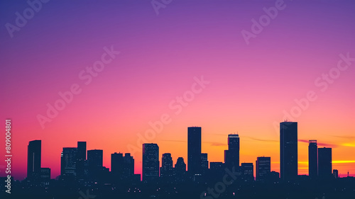 Silhouette of a city skyline against a stunning gradient sunset, featuring shades of pink and purple. 