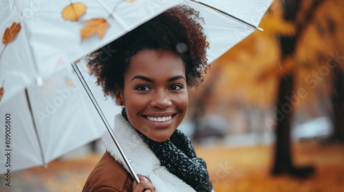 Woman Smiling Under Autumn Umbrella photo