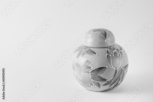Small decorated ceramic bottle. photography turned to black and white in high key