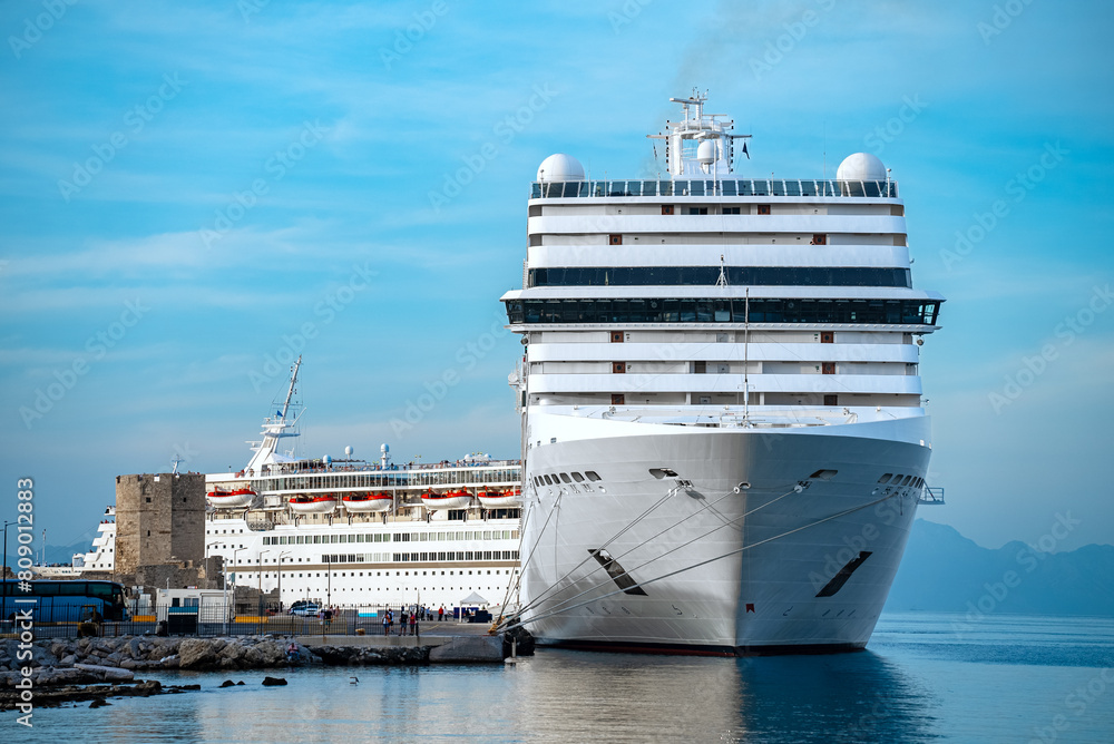 White cruise ship awaits passengers in the port of Rhodes. White cruise ship awaits passengers in the port of Rhodes.