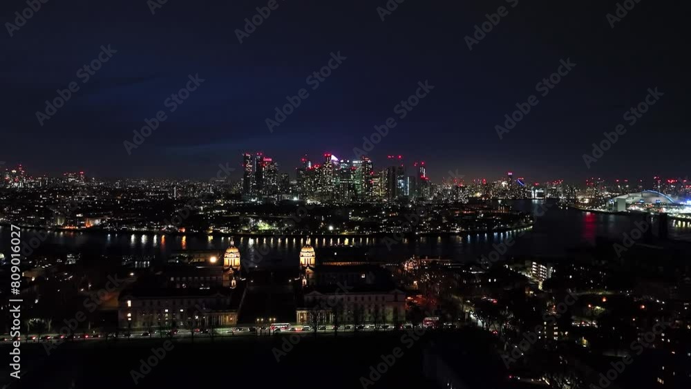 Crane shot of fantastic view of the city at night, skyscrapers glittering white and red lights on the horizon, aerial shot. Crane shot of fantastic view of the city at night, skyscrapers glittering white and red lights on the horizon, aerial shot.