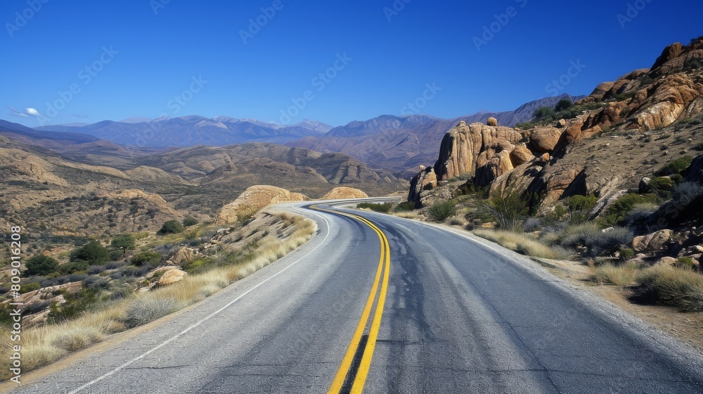 Asphalt highway that smoothly turns into a picturesque mountain landscape, flooded with the warm light of a bright day