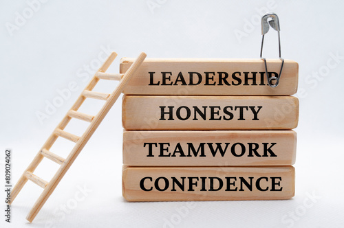 Leadership, honesty, teamwork and confidence text on wooden blocks. Leadership concept.