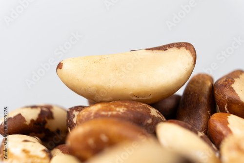 Macro brazil nuts on light grey background.