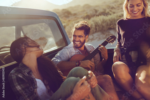Friends enjoying a road trip with drinks and laughter photo