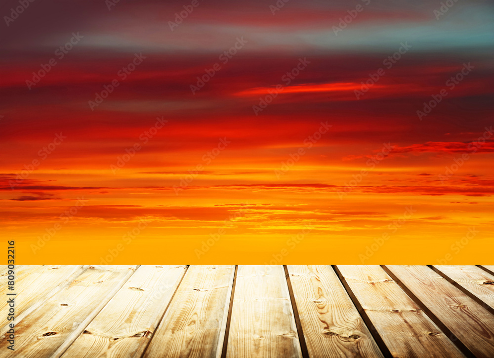 Wooden table on sky background and sunset light
Wooden table on sky background and sunset light
