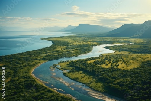 Mozambique landscape. Serene Landscape with River Winding Through Green Valley Beside Blue Lake. © Sci-Fi Agent