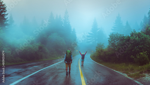 Lover asian man and asian women travel nature. Walk on the road route. traveling nature happily. Amid the mist rainy. photo