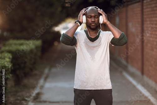 Man with headphones resting after street run