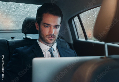 Businessman, car and laptop for transportation service or work travel to meeting, airport or report. Male person, backseat and entrepreneur for tech company or city chauffeur for trip, cab or taxi © peopleimages.com