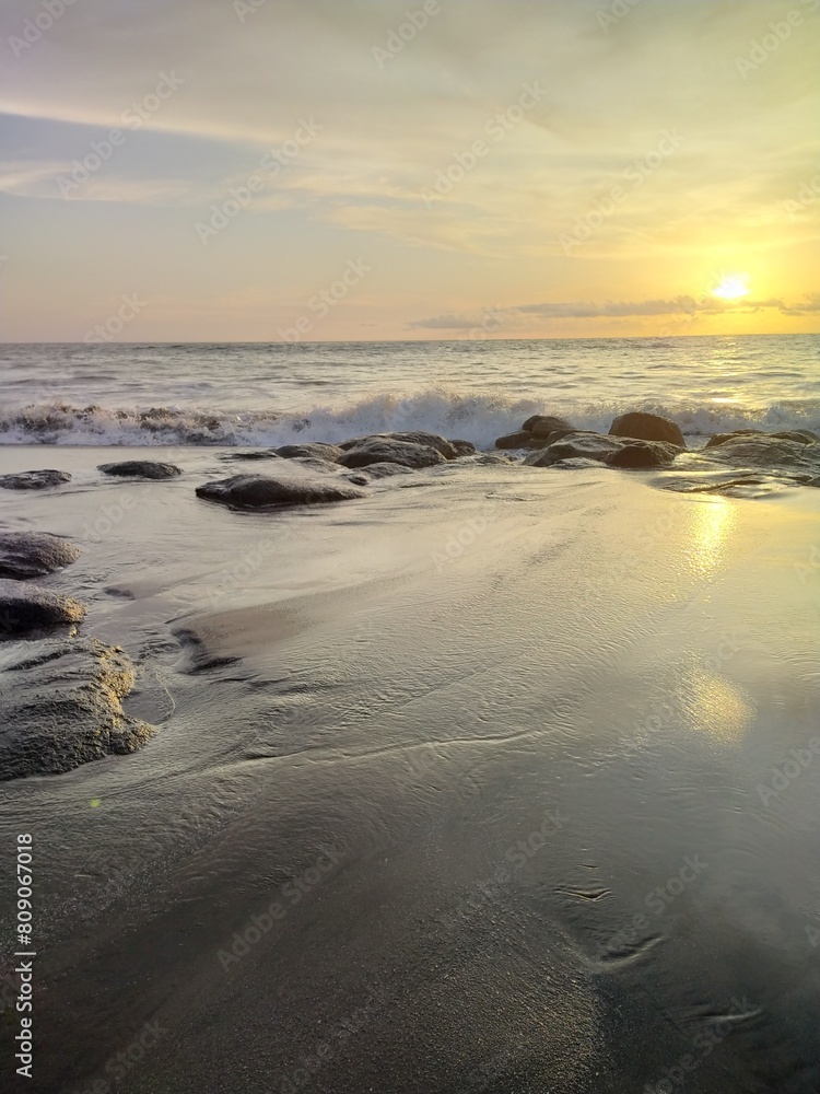 Yellow-orange sunset and sunrise on the ocean shore, Bali island. Epic sunrise, sandy beach. Landscape of Indonesia Yellow-orange sunset and sunrise on the ocean shore, Bali island. Epic sunrise, sandy beach. Landscape of Indonesia