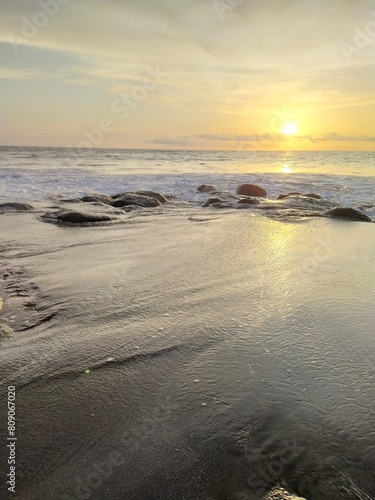 Yellow-orange sunset and sunrise on the ocean shore  Bali island. Epic sunrise  sandy beach. Landscape of Indonesia