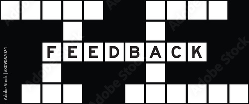 Alphabet letter in word feedback on crossword puzzle background