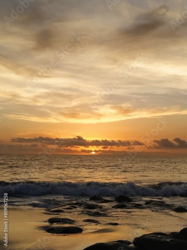 Yellow-orange sunset and sunrise on the ocean shore  Bali island. Epic sunrise  sandy beach. Landscape of Indonesia