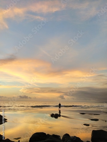 Yellow-orange sunset and sunrise on the ocean shore, Bali island. Epic sunrise, sandy beach. Landscape of Indonesia
