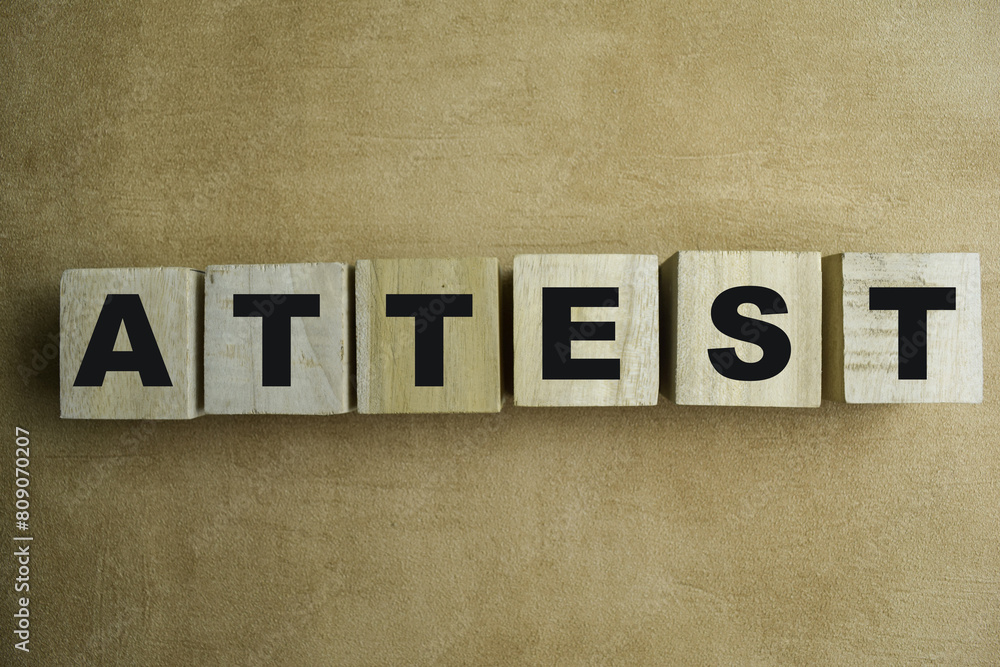 Concept of The wooden Cubes with the word Attest on wooden background. Concept of The wooden Cubes with the word Attest on wooden background.
