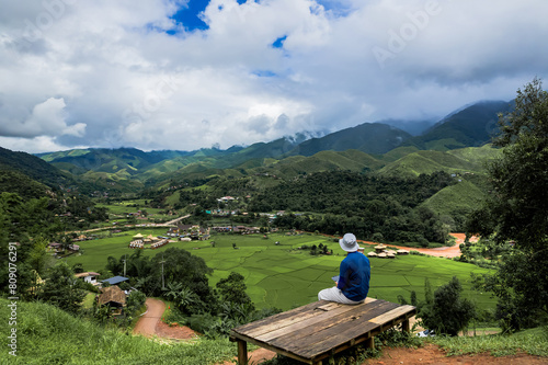 Rear view of tourist man looking to beautiful rice paddy field in Sapan village a small village central mountain. photo