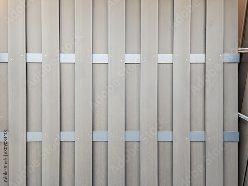 Modern Beige Fence with Metal Clamps Close-Up