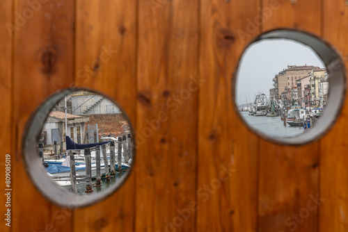 Obraz na płótnie Chioggia cityscape in Venice Lagoon with narrow Vena water canal with colorful boats among old buildings w salonie