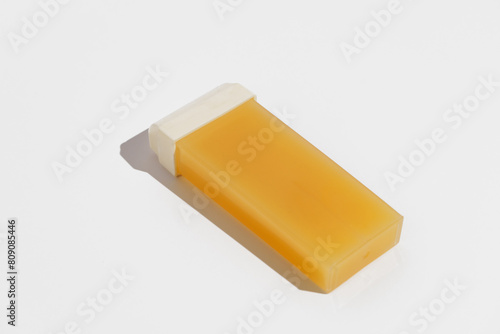 Yellow replaceable wax cassette for depilation on a white isolated background. Concept of body hair removal, beauty procedures