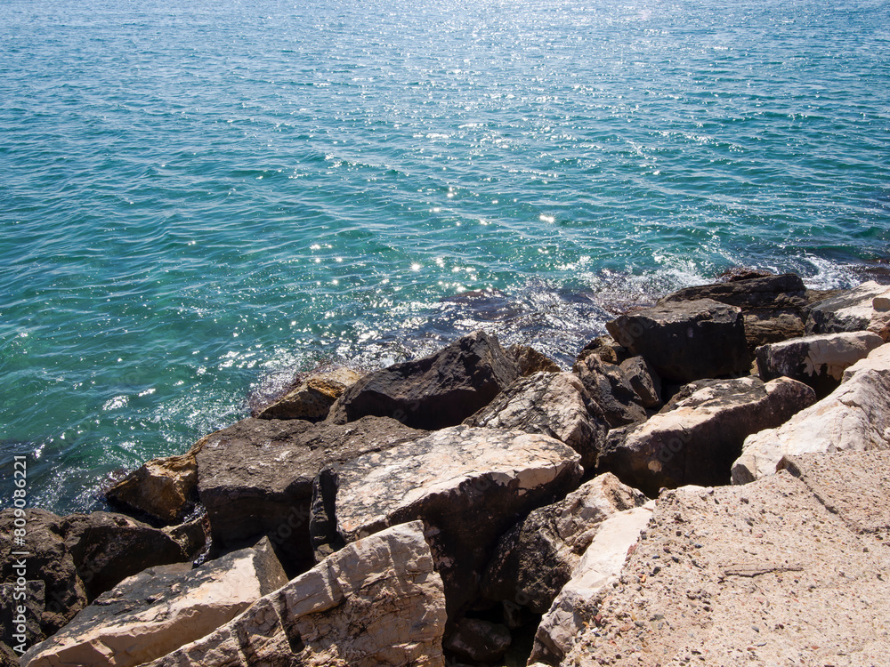 Photo on the surface of crashed waves on the beach of the coast. Tropical surf on the beach. waves on the golden sand of the beach. Fantastic sea view with calm sea water waves and sunlight