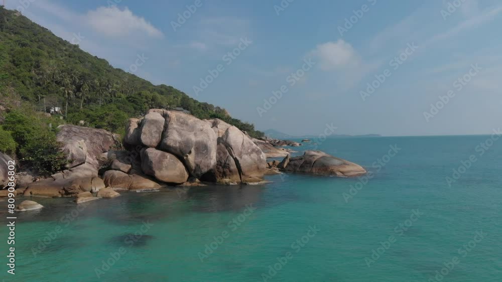 Aerial drone view of Crystal Bay Beach in Koh Samui, highlighting dramatic rock formations along clear turquoise waters Aerial drone view of Crystal Bay Beach in Koh Samui, highlighting dramatic rock formations along clear turquoise waters
