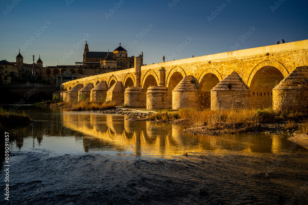 Sunset Over the Roman Bridge on Guadalquivir River in Cordoba, Spain Sunset Over the Roman Bridge on Guadalquivir River in Cordoba, Spain