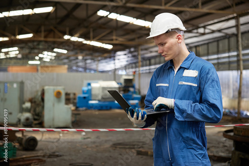 technician or engineer working on laptop computer in the factory