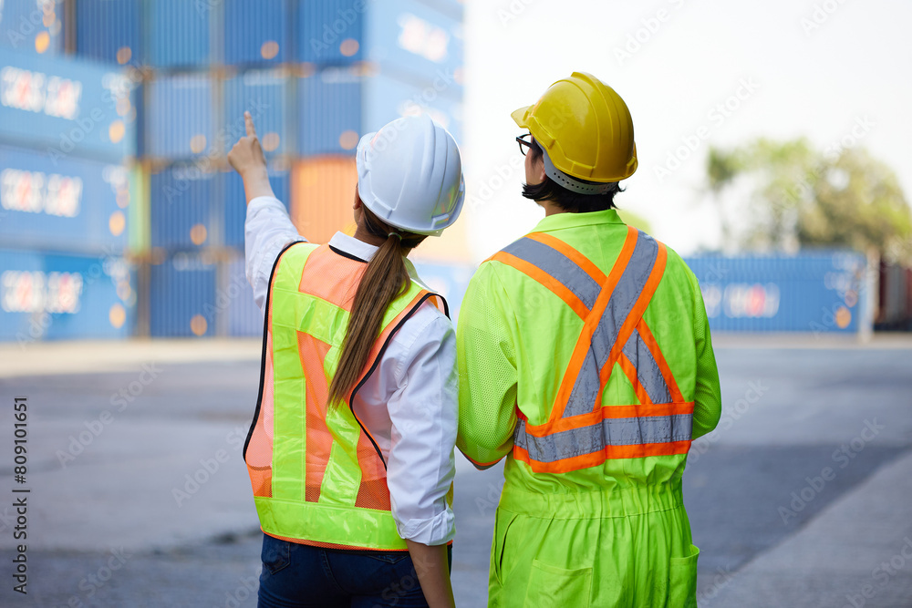 back view workers looking and pointing above in containers warehouse storage back view workers looking and pointing above in containers warehouse storage