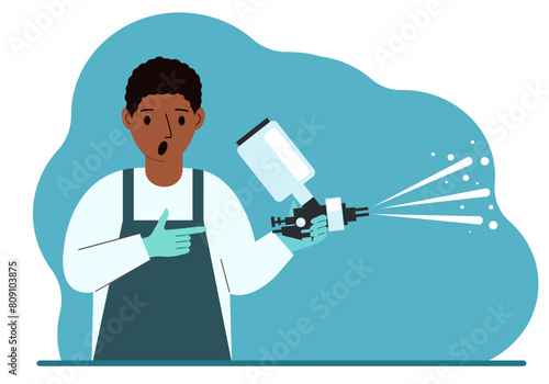 A man in a special suit holds a paint spray gun.