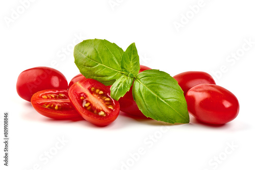 Cherry tomatoes with basil leaves, isolated on white background © GSDesign