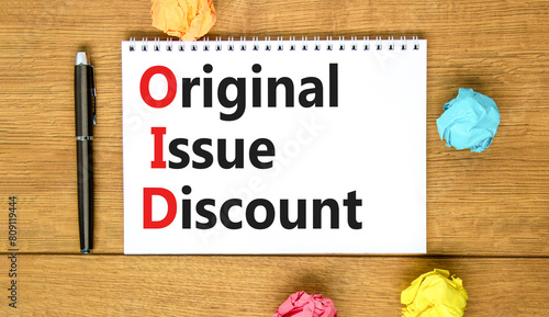 OID original issue discount symbol. Concept words OID original issue discount on beautiful white note. Beautiful wooden table background. Business OID original issue discount concept. Copy space.