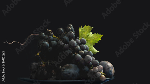 natural dark background with a plate of dark grapes and plums