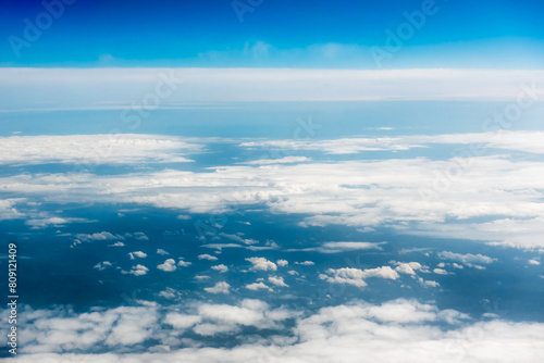Fototapeta Naklejka Na Ścianę i Meble -  White cumulus clouds on clear blue sky background closeup, overcast skies backdrop, fluffy cloud texture, beautiful sunny cloudscape heaven. White clouds view from airplane