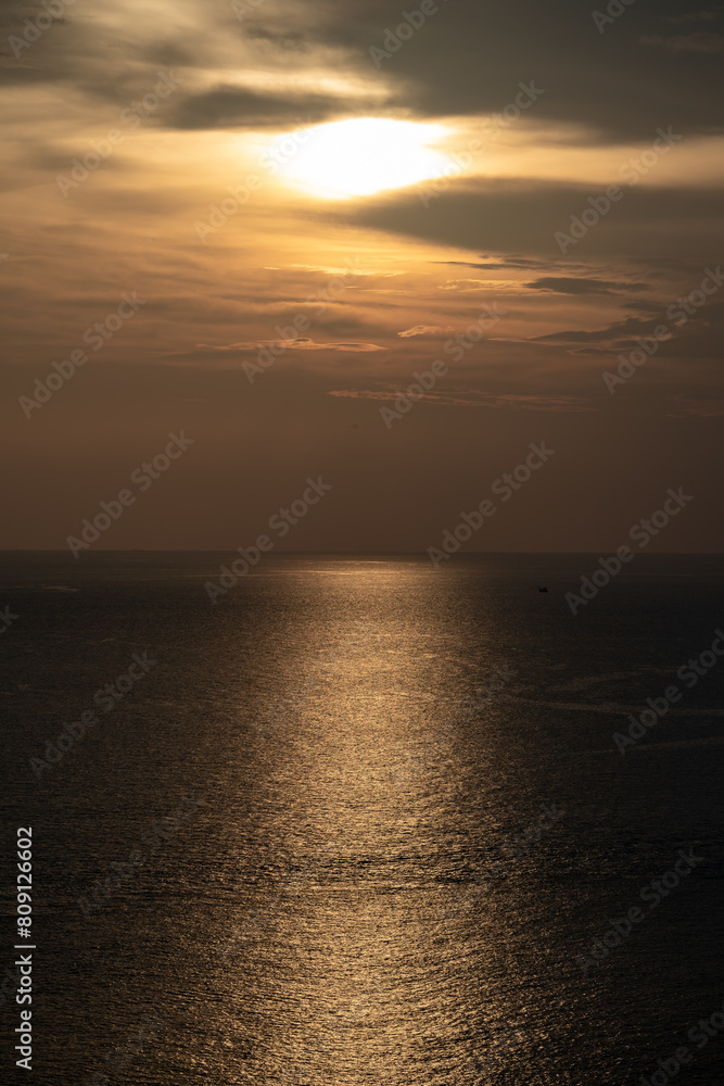 Twilight Golden time in the sea view of Phrom Thep Cape, the tropical sea sunset period, scenic point of Phuket Island, The Pearl of the Andaman Sea,Thailand popular for tourist in the world. Twilight Golden time in the sea view of Phrom Thep Cape, the tropical sea sunset period, scenic point of Phuket Island, The Pearl of the Andaman Sea,Thailand popular for tourist in the world.