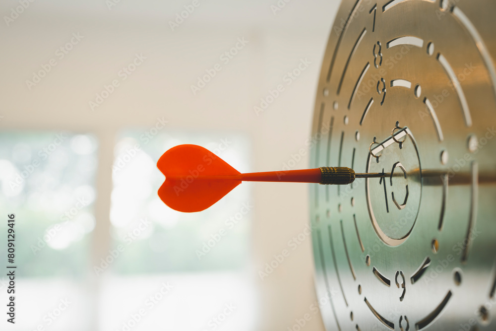 Darts with dartboard, sunset sky background hitting target. Achieve Goals - Success. Darts with dartboard, sunset sky background hitting target. Achieve Goals - Success.
