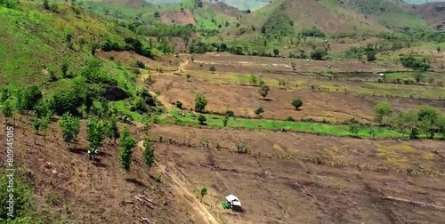 aerial video of deforested forests in mountainous areas being converted into agricultural land