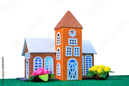 Small toy chapel with light in the windows