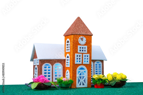 Small orange toy chapel with lights in the windows