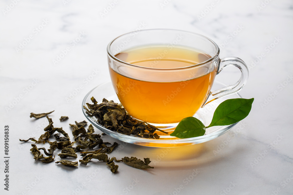 Cup of healthy green tea with tea leaves. Cup of healthy green tea with tea leaves.